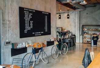 two bikes parked beside wall inside room