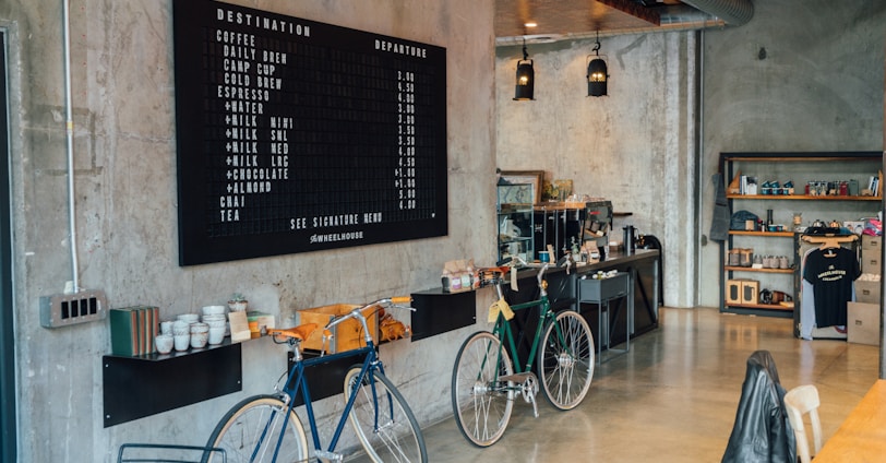 two bikes parked beside wall inside room