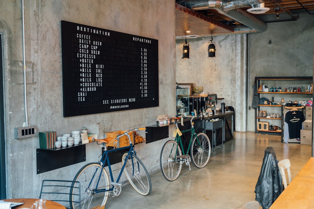 two bikes parked beside wall inside room