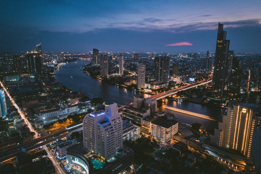 aerial photography of buildings near body of water during night