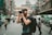 shallow focus photography of man using a DSLR camera