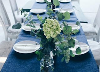 green and white flower centerpiece on table