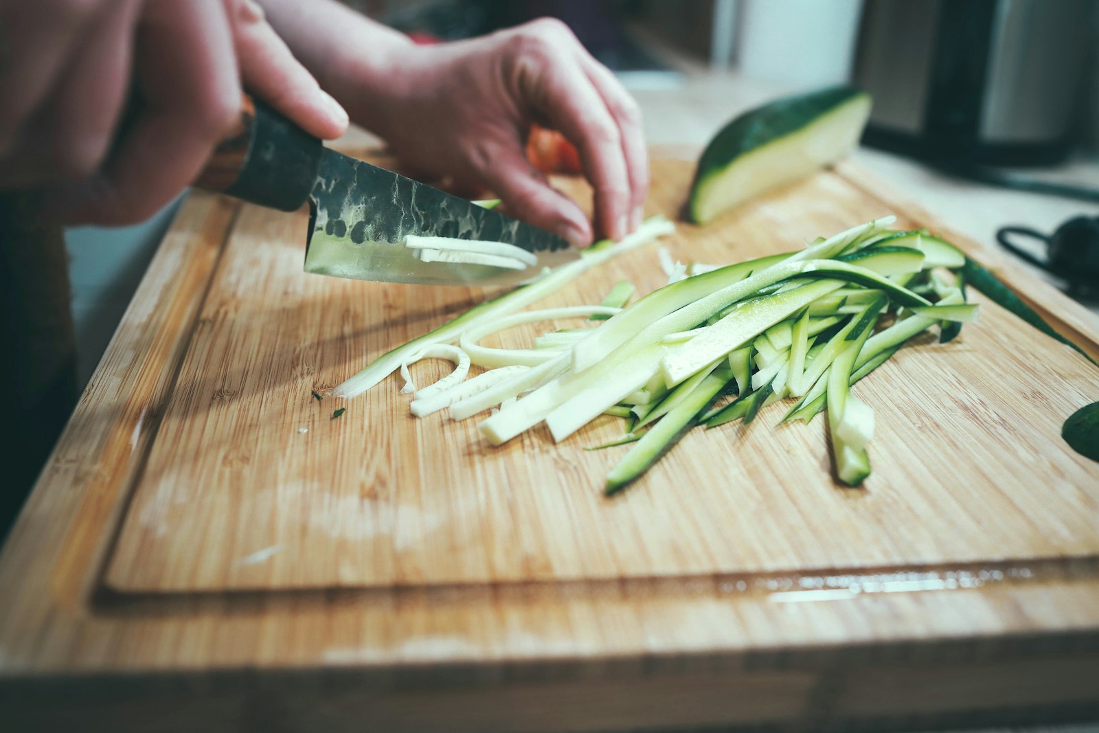 Canon EF 35mm F1.4L USM sample photo. Person slicing cucumber photography