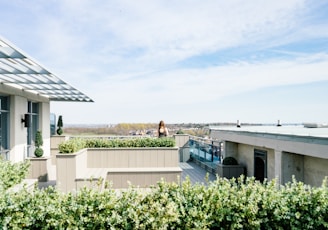 woman on balcony during cloudy skies