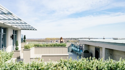 woman on balcony during cloudy skies