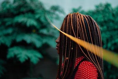 shallow focus of woman in dreadlocks during daytime style teams background