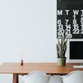 silver iMac on brown wooden desk