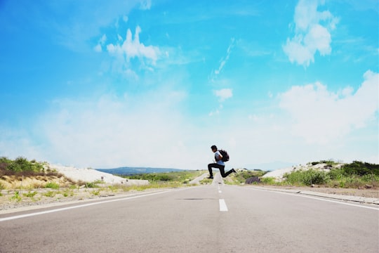 man jumping on street during daytime in Mui Ne Vietnam