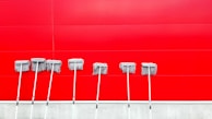 An assortment of colorful mops arranged neatly.