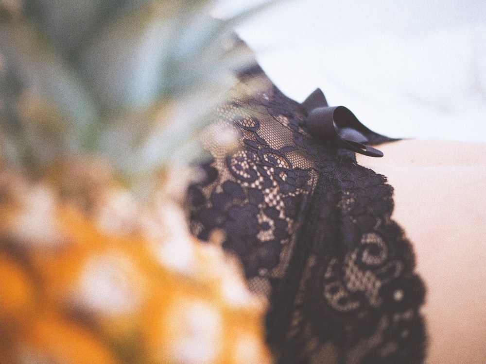 a close up of a woman's black lace top