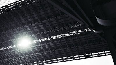 Steel frame construction of a foot over bridge under bright sunlight.