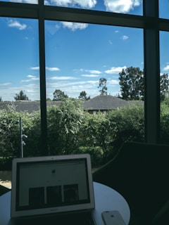 A serene workspace with a laptop open to ptc learning’s dashboard, sunlight streaming in through a window.