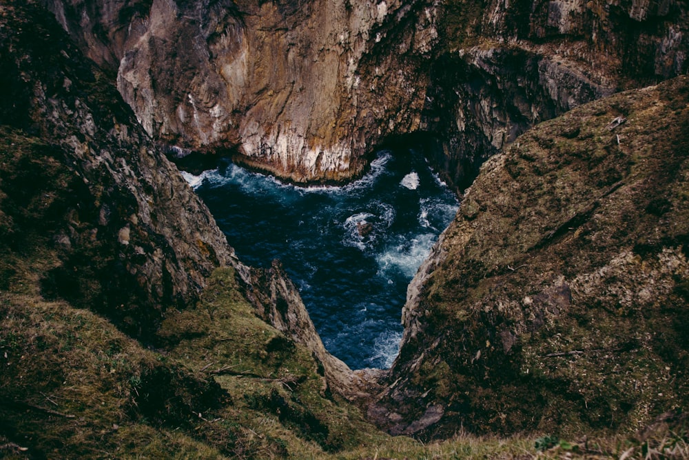 aerial photography of mountain near body of water