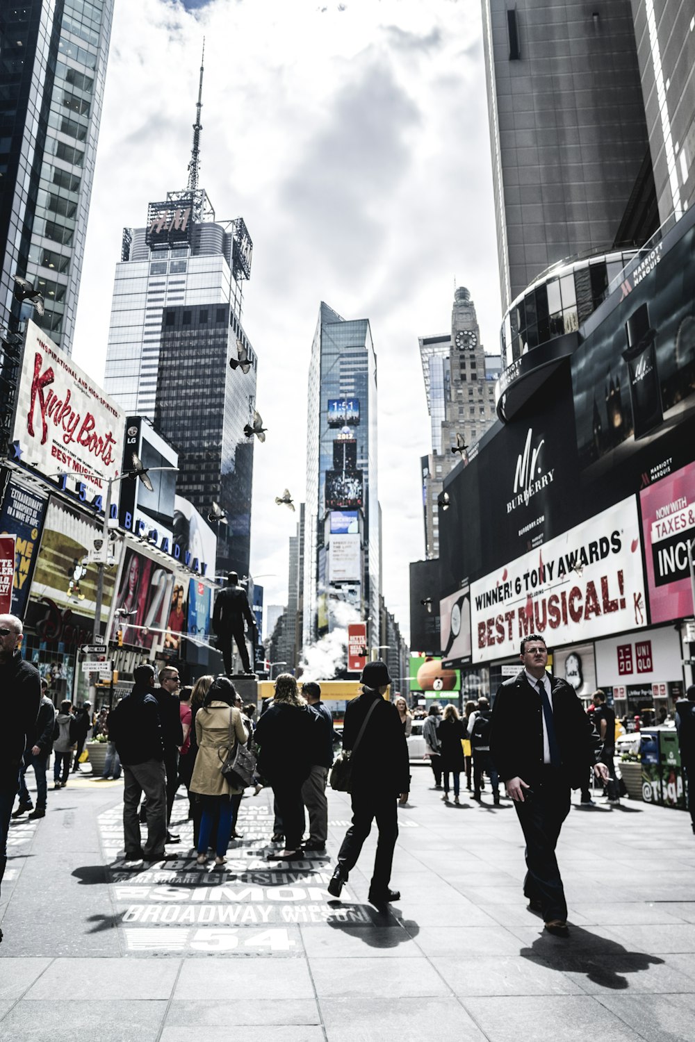 people walking in street beside buildings