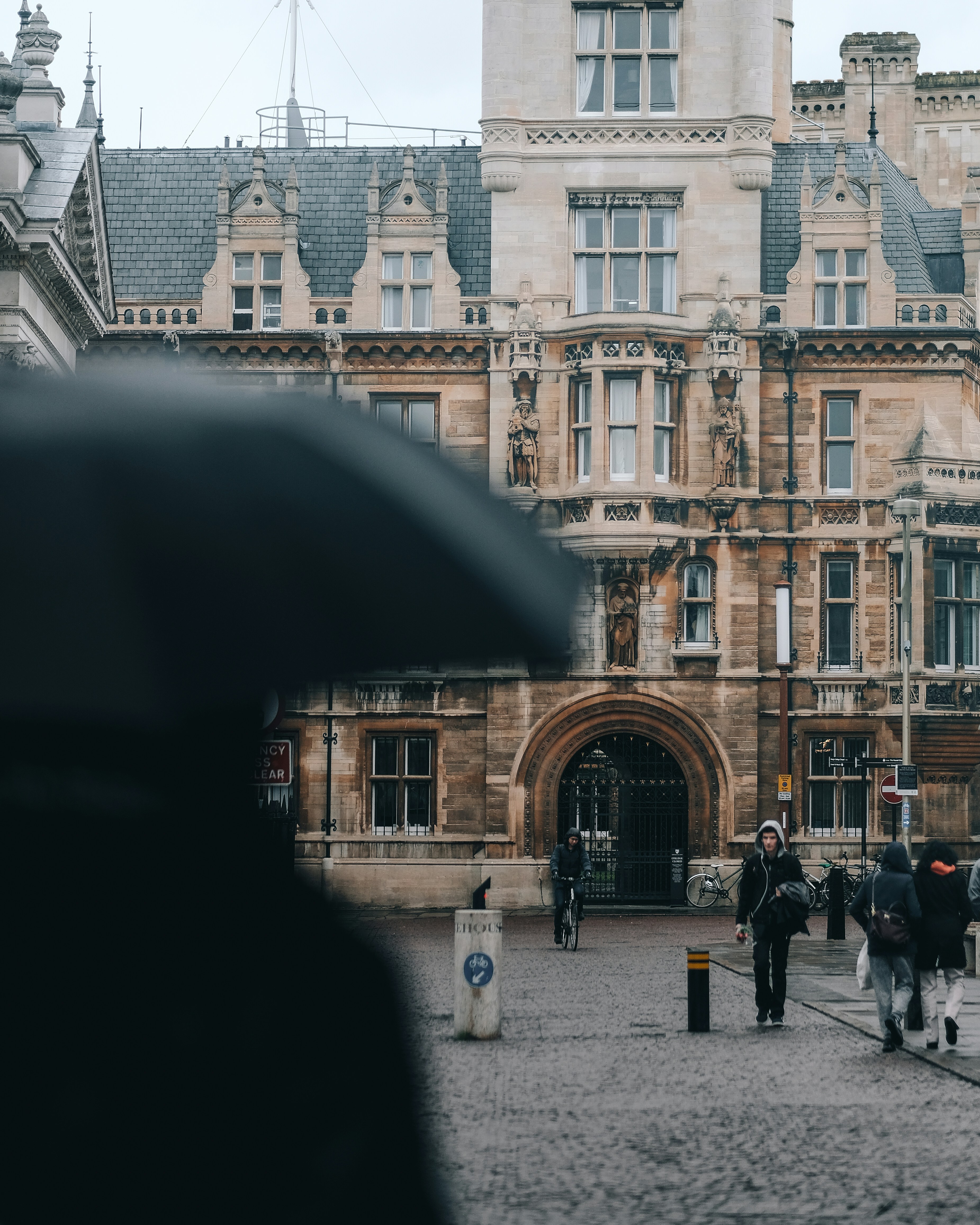 people walking in front of brown concrete building