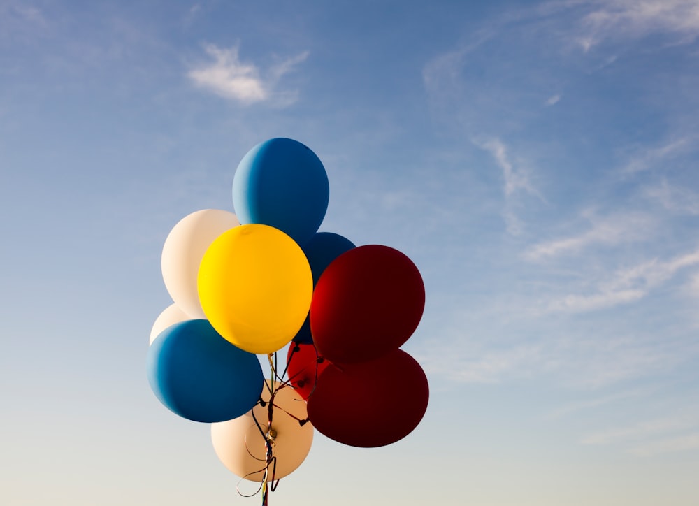 Colorful balloons on a string against a blue sky