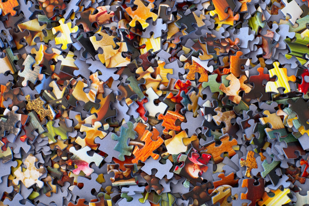 An aerial shot of brightly-colored jigsaw puzzle pieces