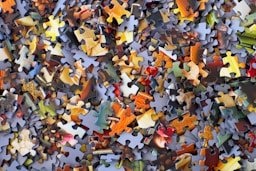 stack of jigsaw puzzle pieces by Hans-Peter Gauster (@sloppyperfectionist)
