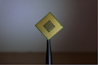 person holding computer cell processor by Brian Kostiuk (@briankost)