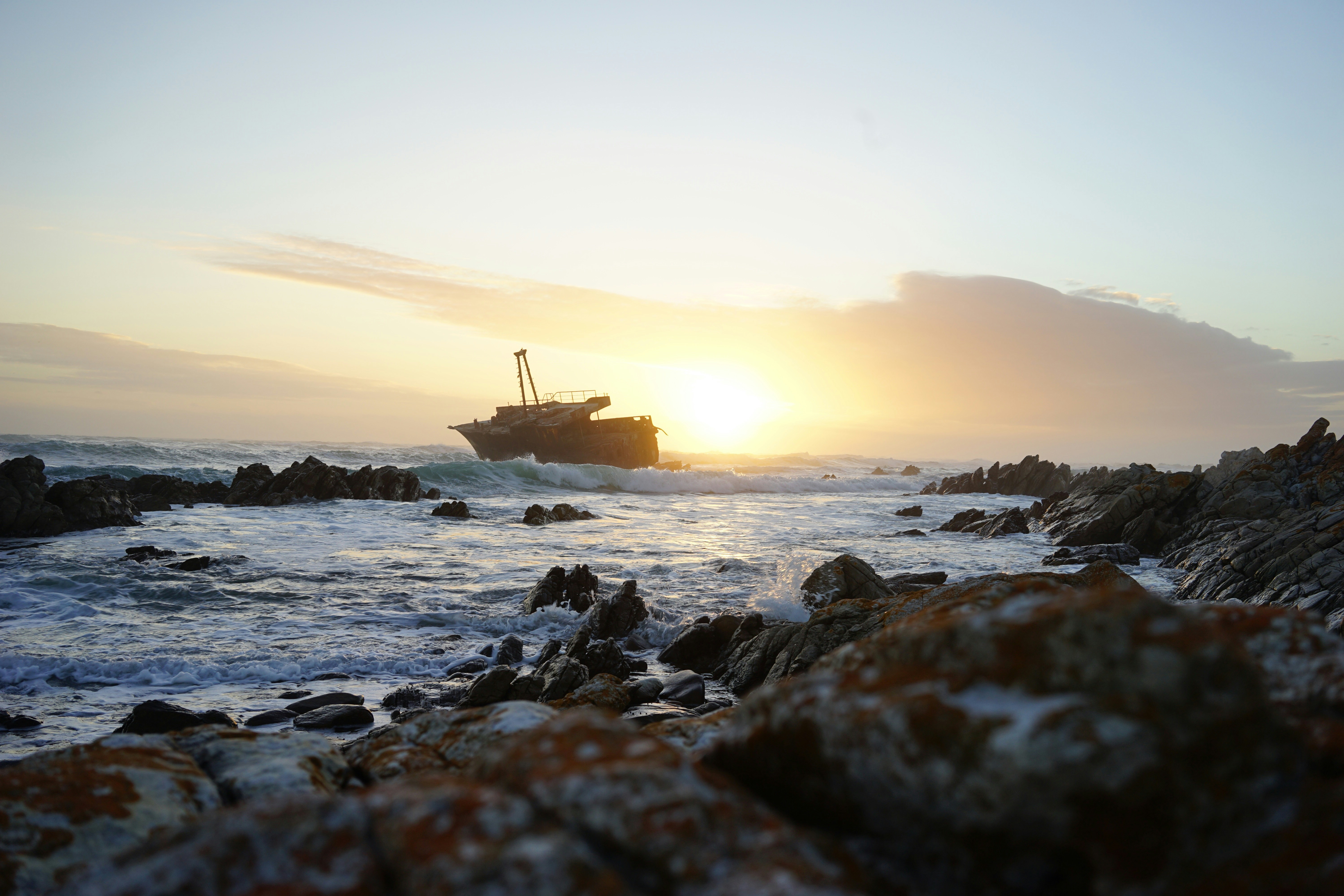 ship near shore, On my world tour in 2016 i went to South Africa and travelled the garden route. On the most southern point of Africa i found this sunken ship in the bay. With the sunset it gave this hole picture such an quite atmosphere.