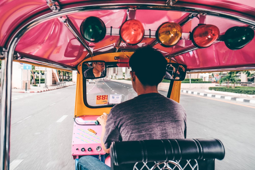 A man driving an auto rickshaw in Bangkok