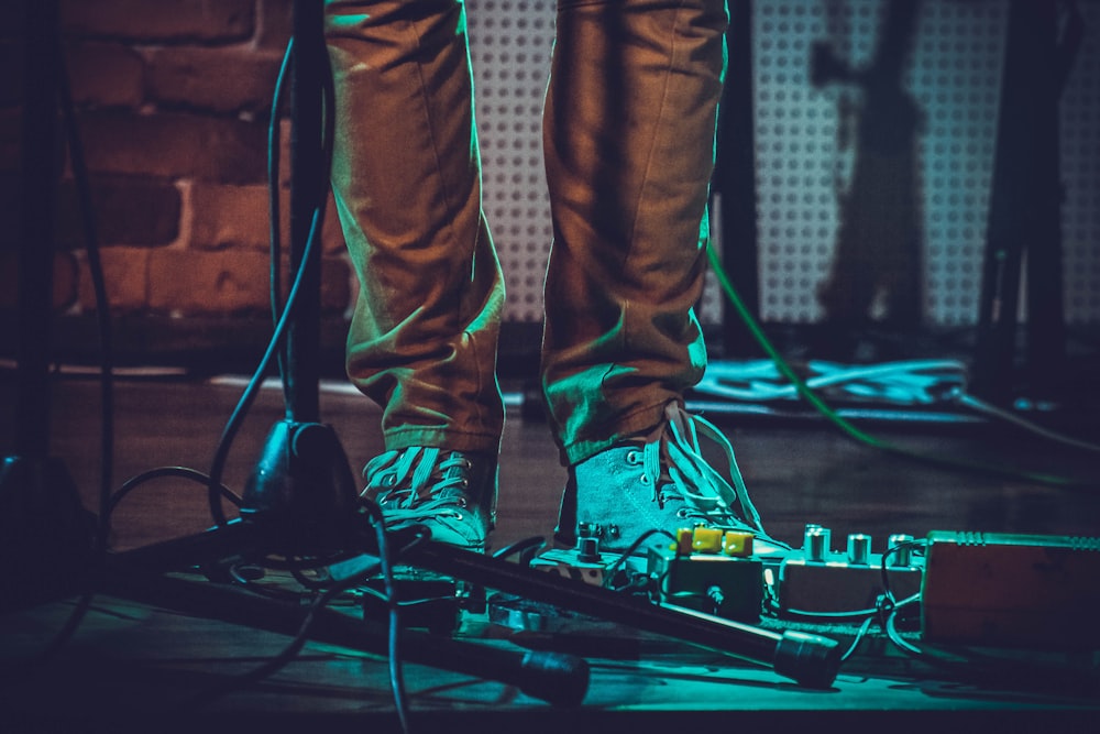 person standing beside black microphone stand