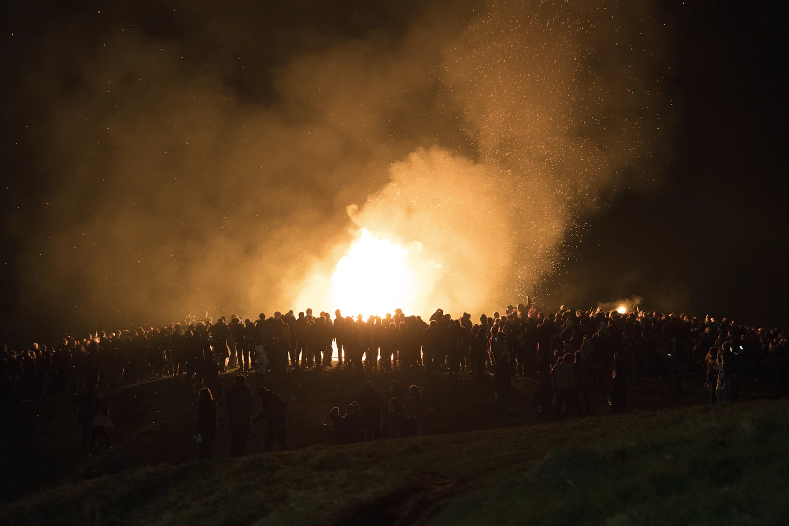 People gathered in a sacred circle around a fire