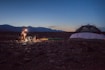 person camping beside white and black tent