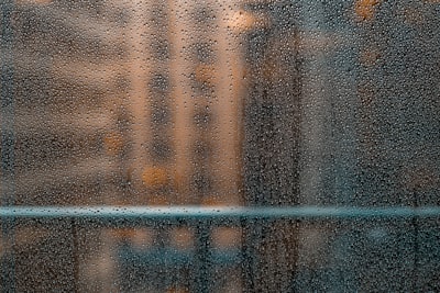 black metal fence near building raindrop zoom background