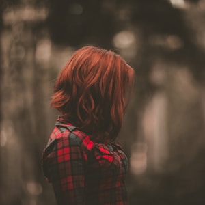 focused photo of a woman wearing red long-sleeved dress