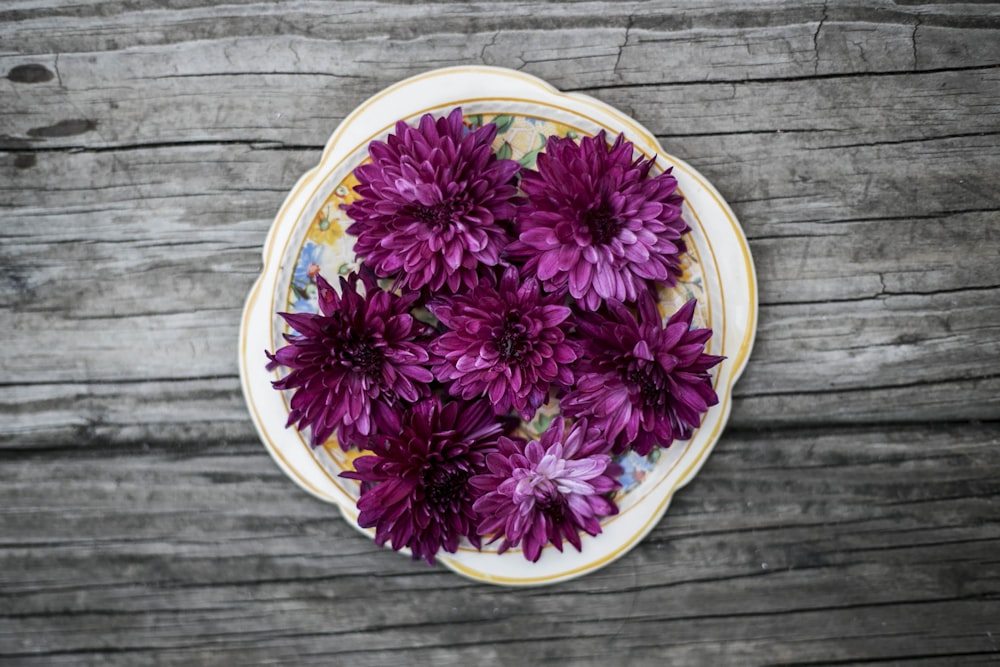 pink petaled flowers on white ceramic plate