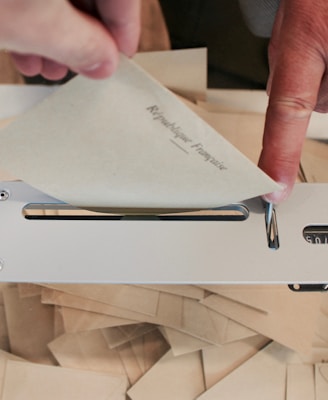 person holding white machine on top of white table