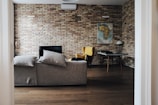 gray wooden table beside wing chair