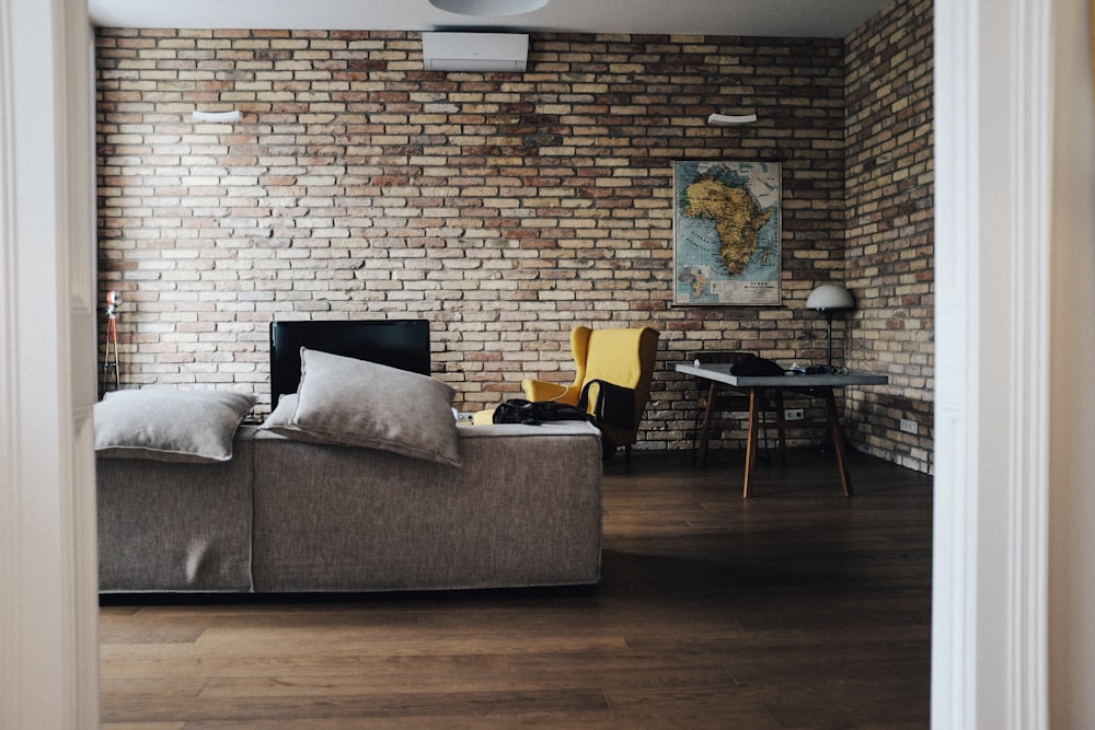 gray wooden table beside wing chair