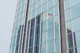 A close-up of a spotless commercial storefront window reflecting Ottawa’s skyline.
