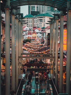 people gathered on the streets surrounded by stalls and buildings