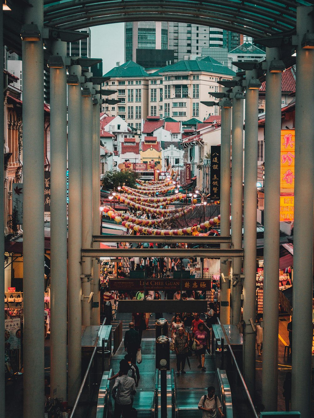 people gathered on the streets surrounded by stalls and buildings