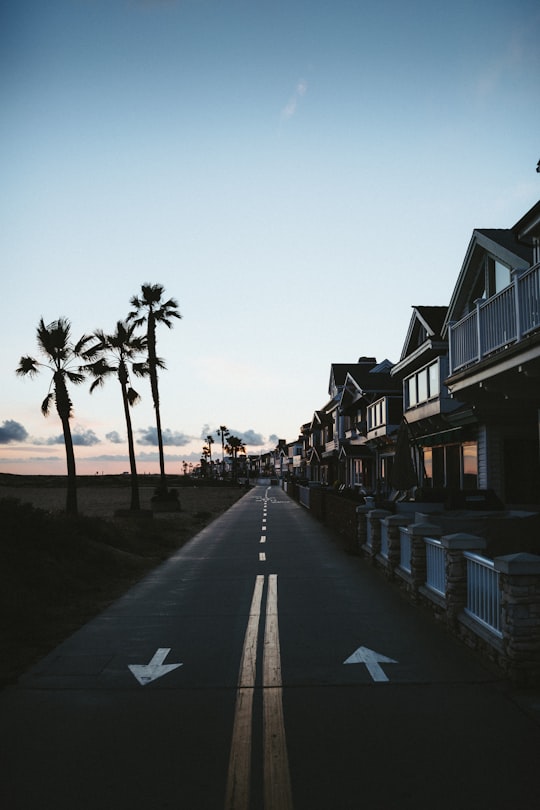 people walking on sidewalk near houses during daytime in Newport Beach United States