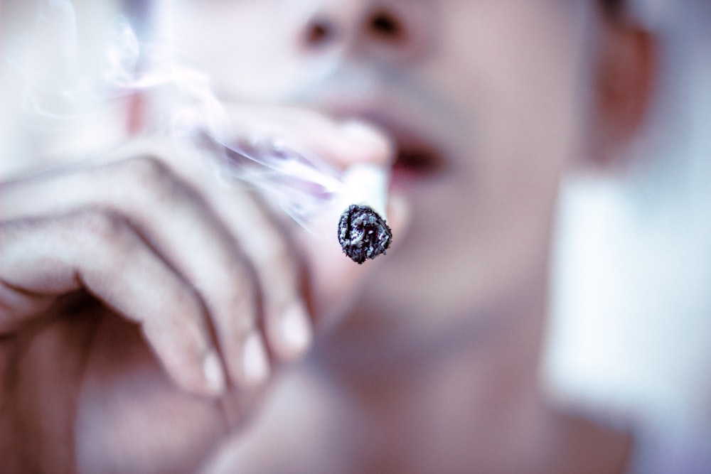 selective focus of man hitting cigarette