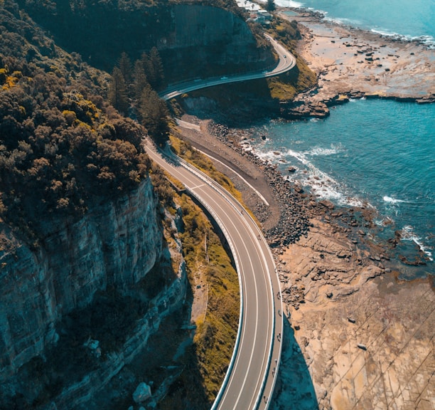 birds eye view of highway beside bay