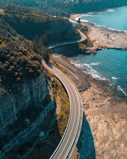 birds eye view of highway beside bay