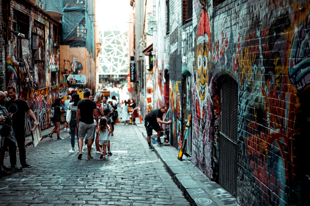 man and girl walking beside building, Art spotting