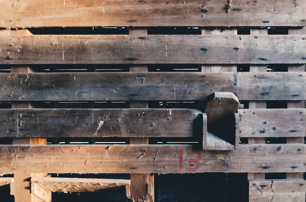 a bunch of wooden pallets stacked on top of each other