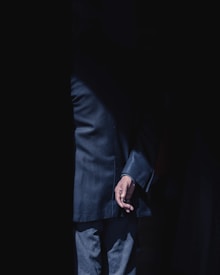 person wearing black formal suit