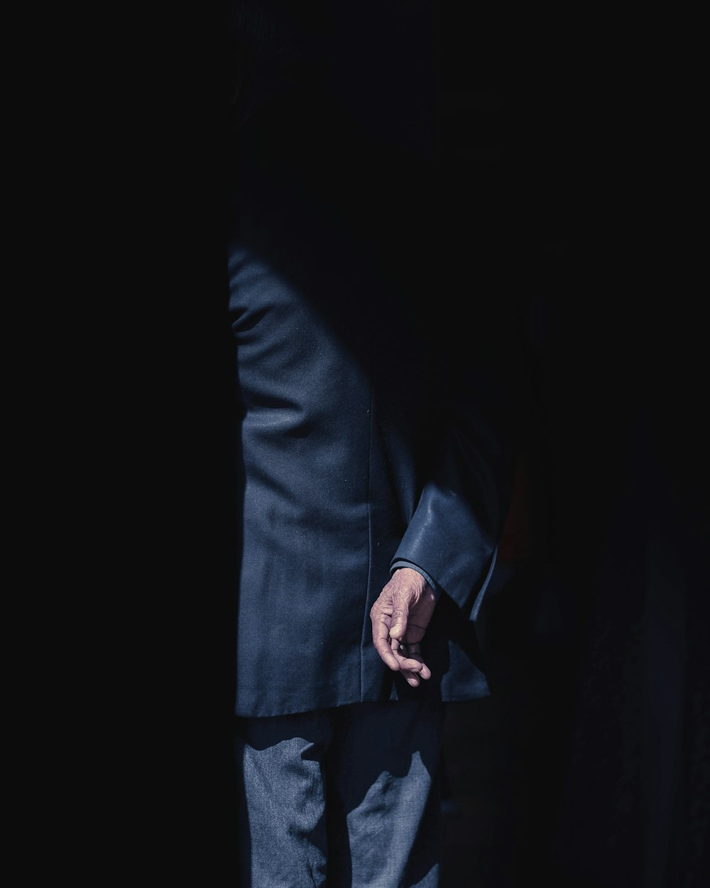 person wearing black formal suit