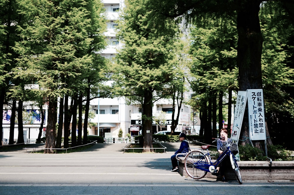 woman sitting on concrete block