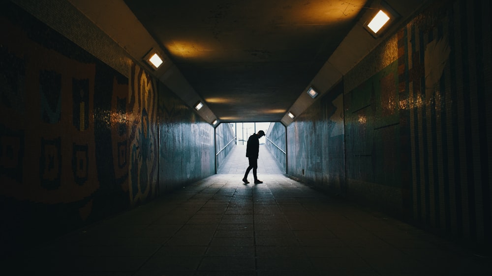 silhouette of a man inside subway