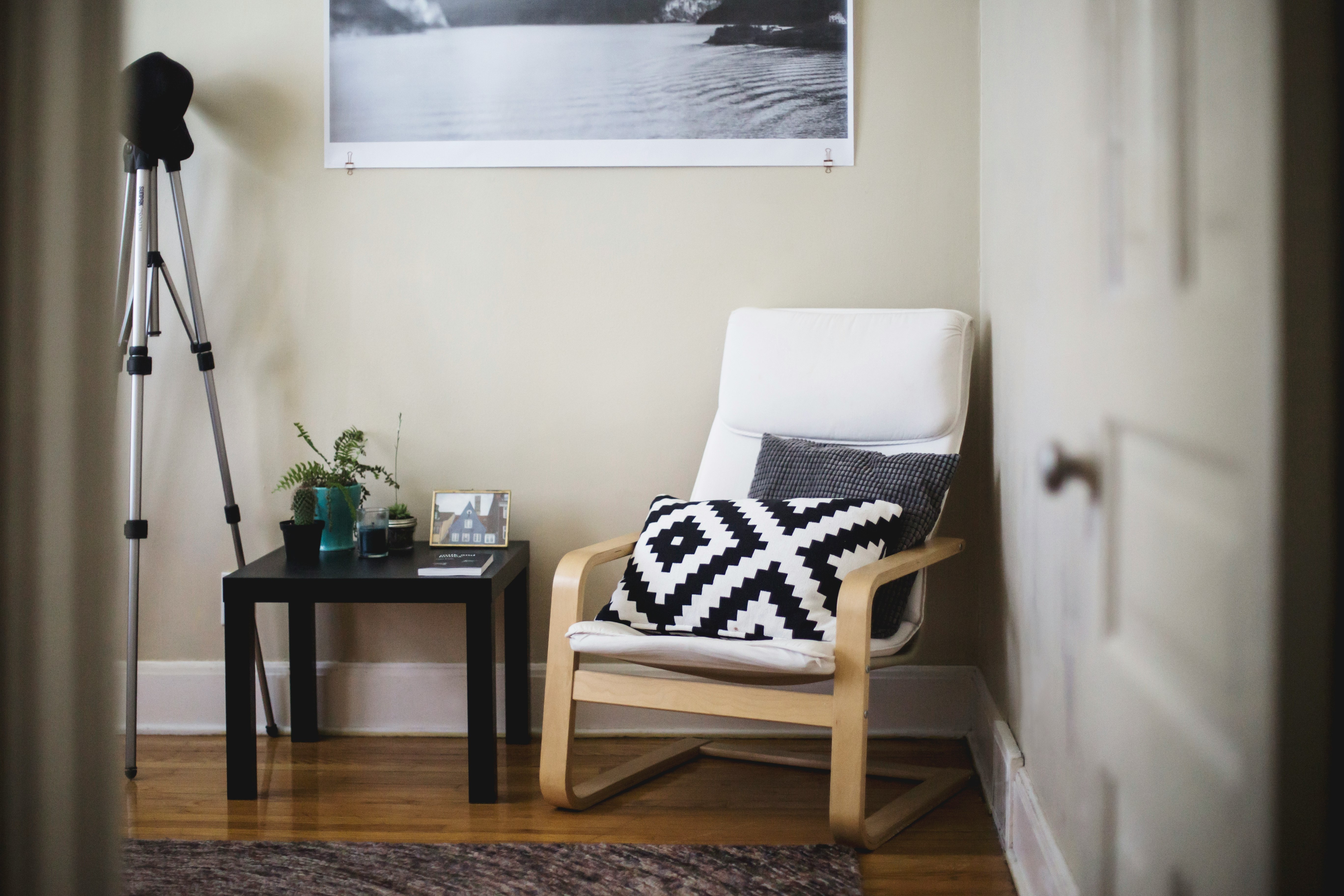 throw pillow on chair beside end table inside room