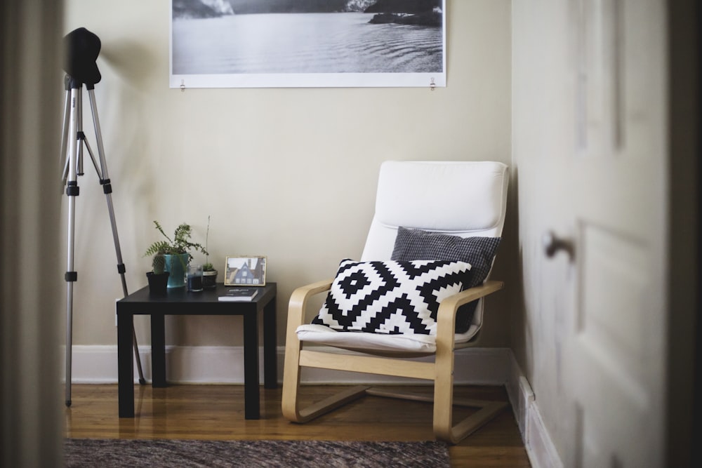 throw pillow on chair beside end table inside room