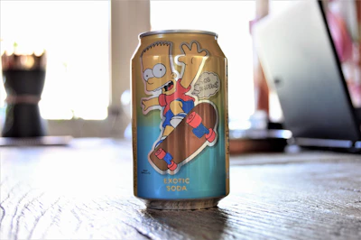 Close-up of a classic soda can featuring a Simpsons-themed design